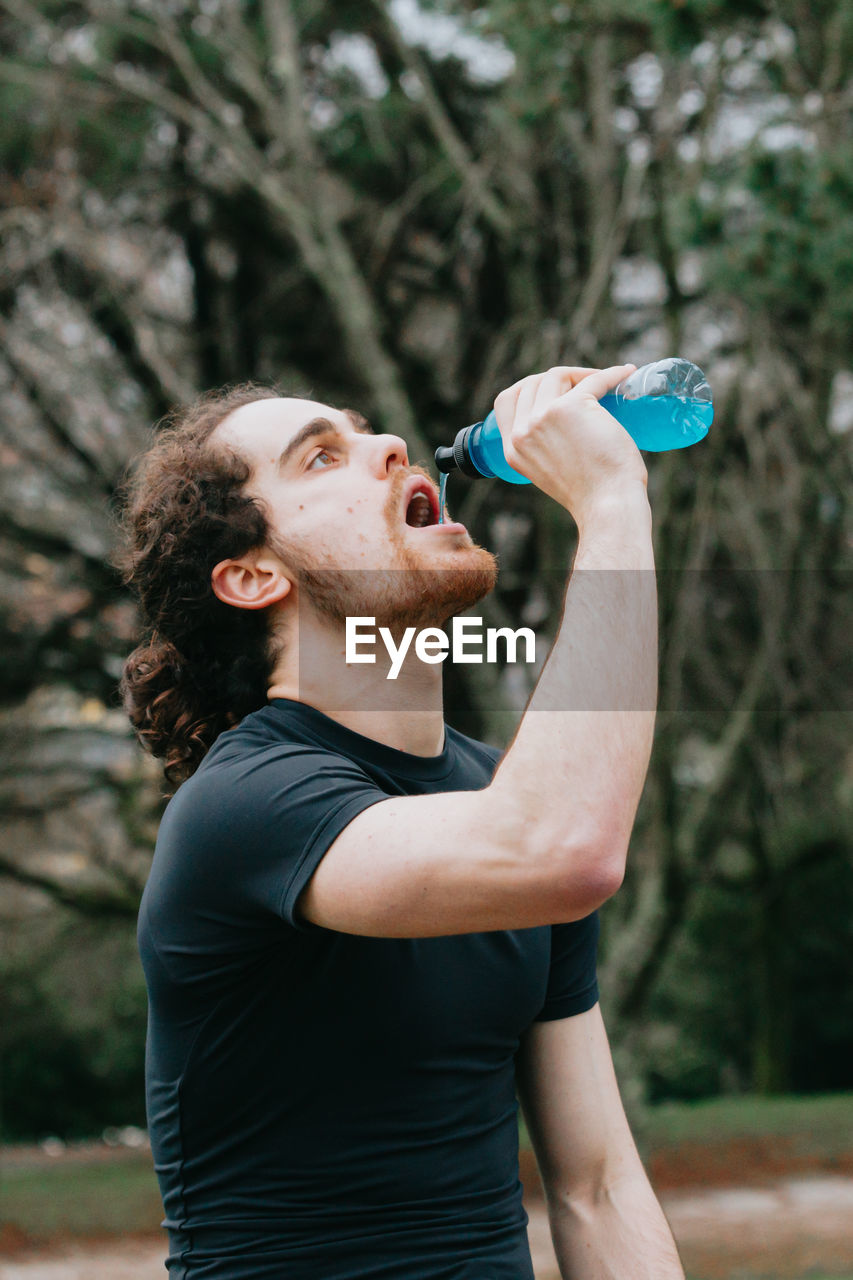 side view of woman drinking water