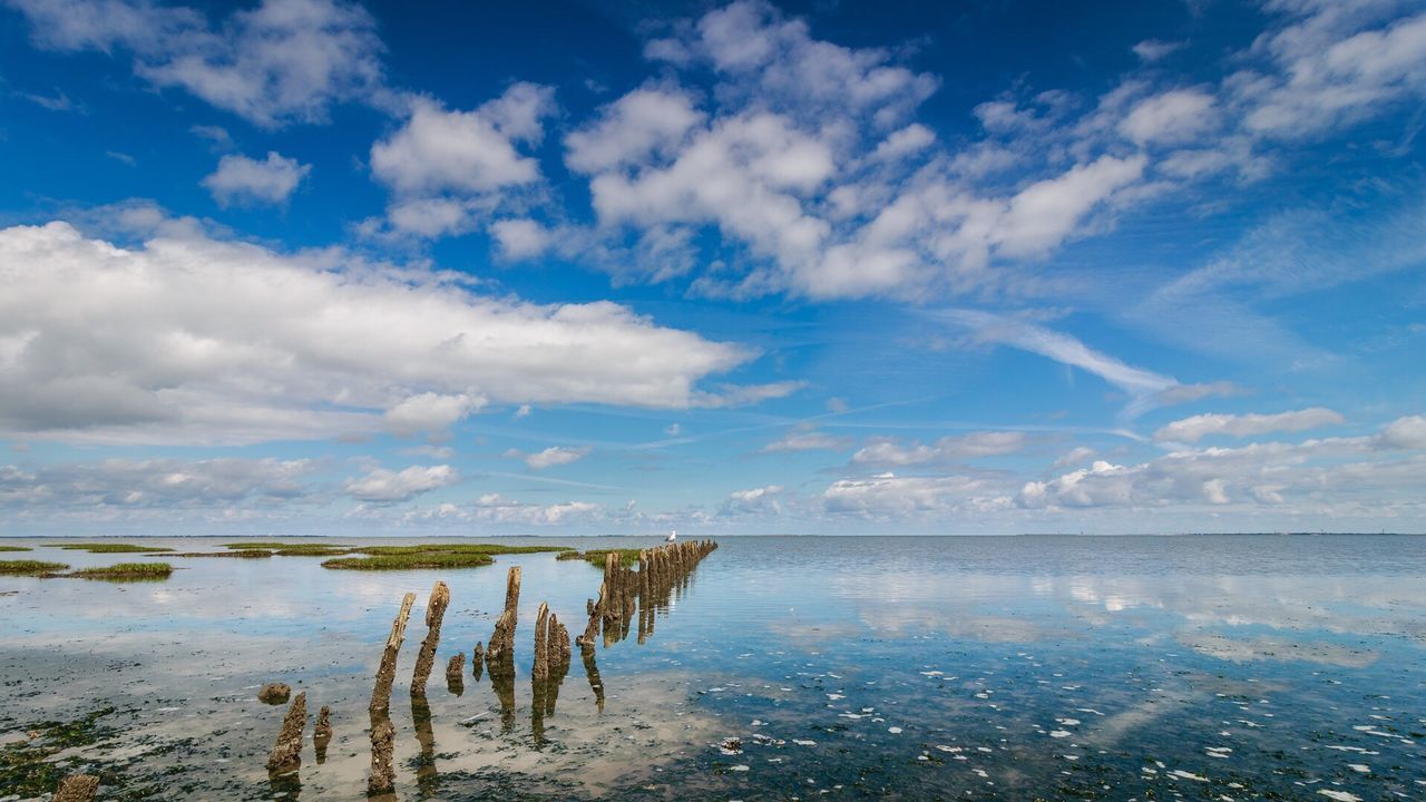 Scenic view of lake against cloudy sky