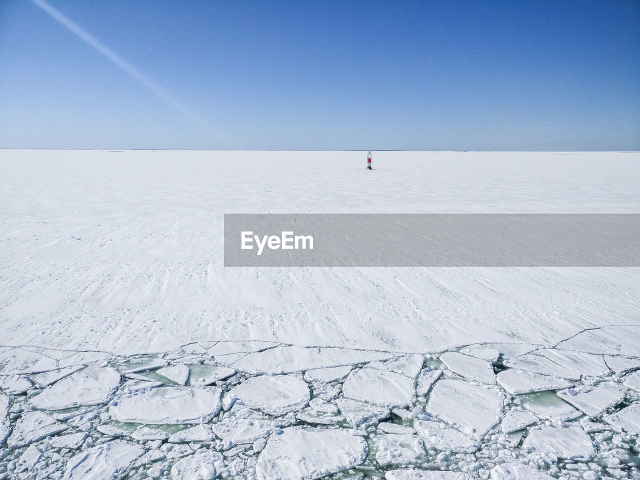 Scenic view of snow covered landscape against blue sky