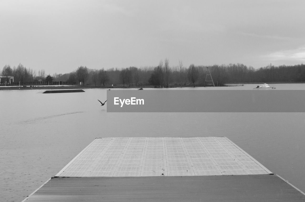 Scenic view of lake against sky during winter