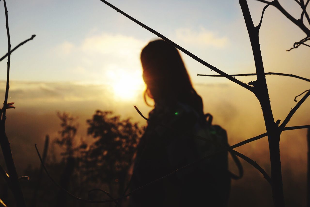 SILHOUETTE OF MAN AGAINST SUNSET SKY