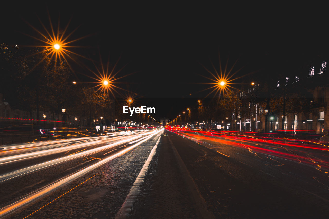 Light trails on road in city at night