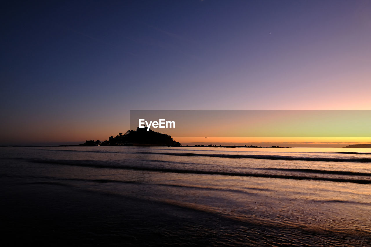 Scenic view of sea against sky at sunset