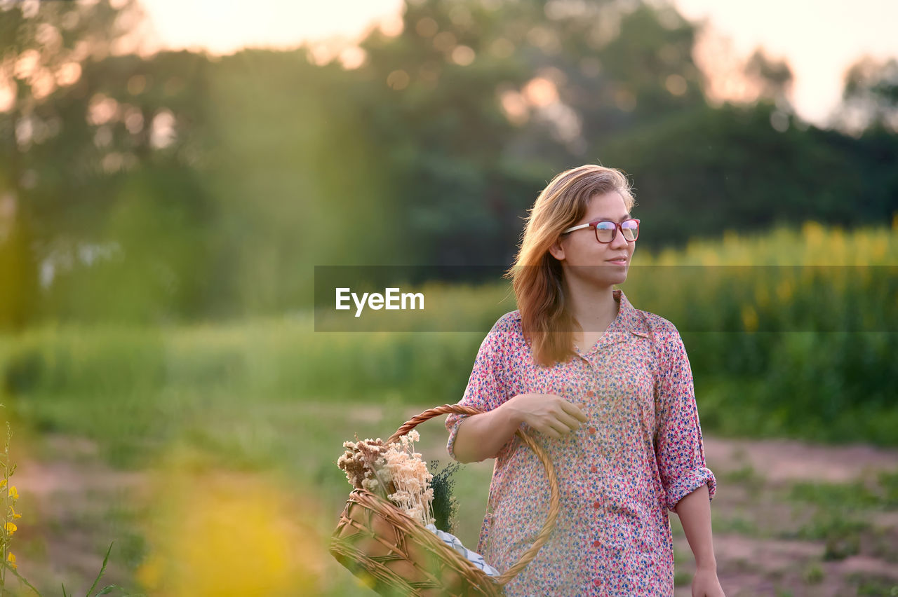 Portrait of woman walking in the rural field