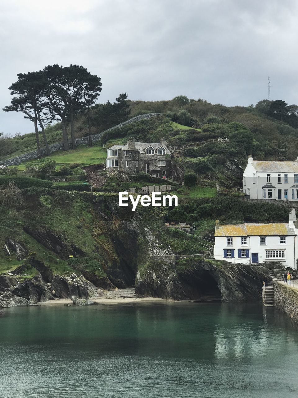 Scenic view of river by buildings against sky