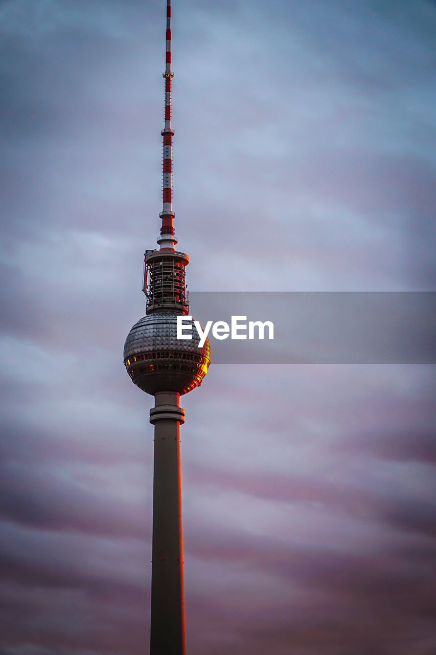 Low angle view of communications tower against sky