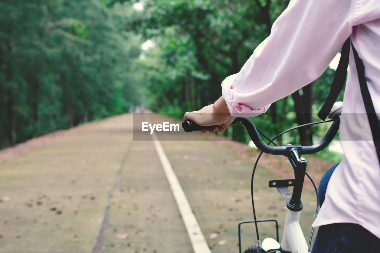 Close-up of person riding bicycle on road