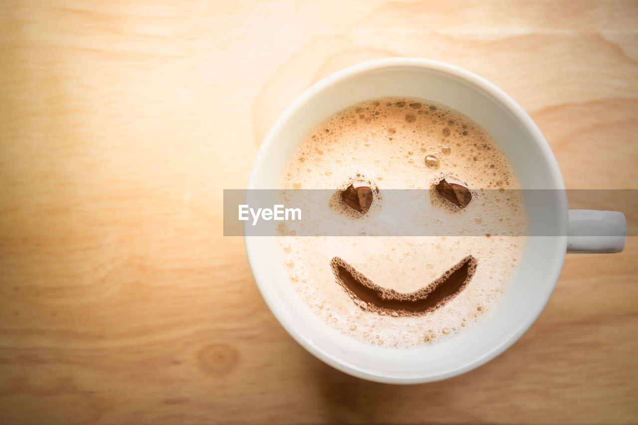 Directly above shot of cappuccino served on table