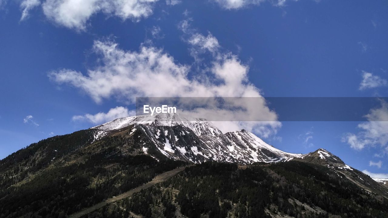 mountain, sky, cloud, scenics - nature, mountain range, beauty in nature, snow, environment, landscape, mountain peak, nature, cold temperature, snowcapped mountain, ridge, winter, no people, travel destinations, summit, blue, stratovolcano, non-urban scene, outdoors, travel, land, plateau, day, volcano, tranquil scene, tranquility, tourism, geology