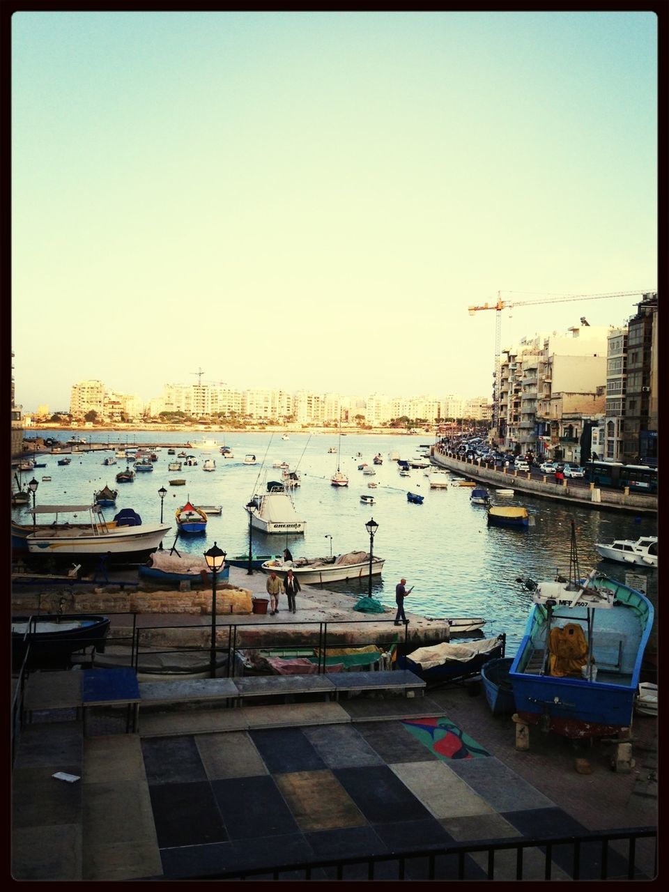 View of boats in harbor against sky