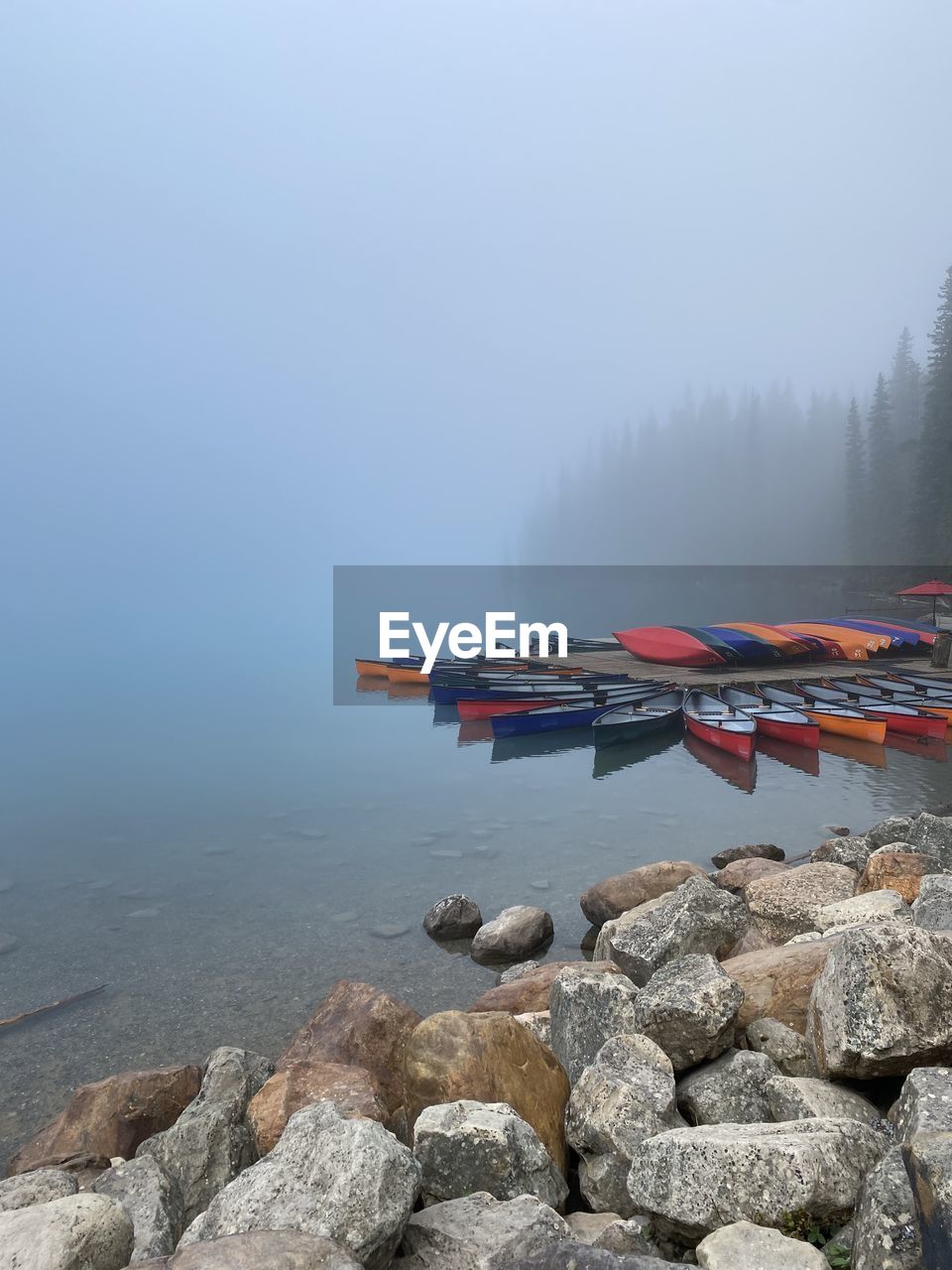 Scenic view of  foggy alpine lake  at sunrise 