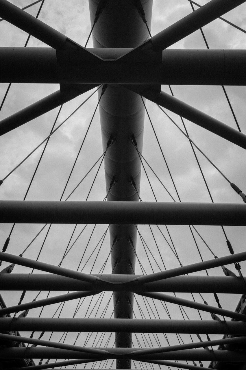 Low angle view of bridge cables against sky