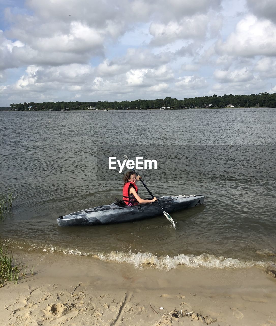 MAN ON BOAT AT BEACH AGAINST SKY