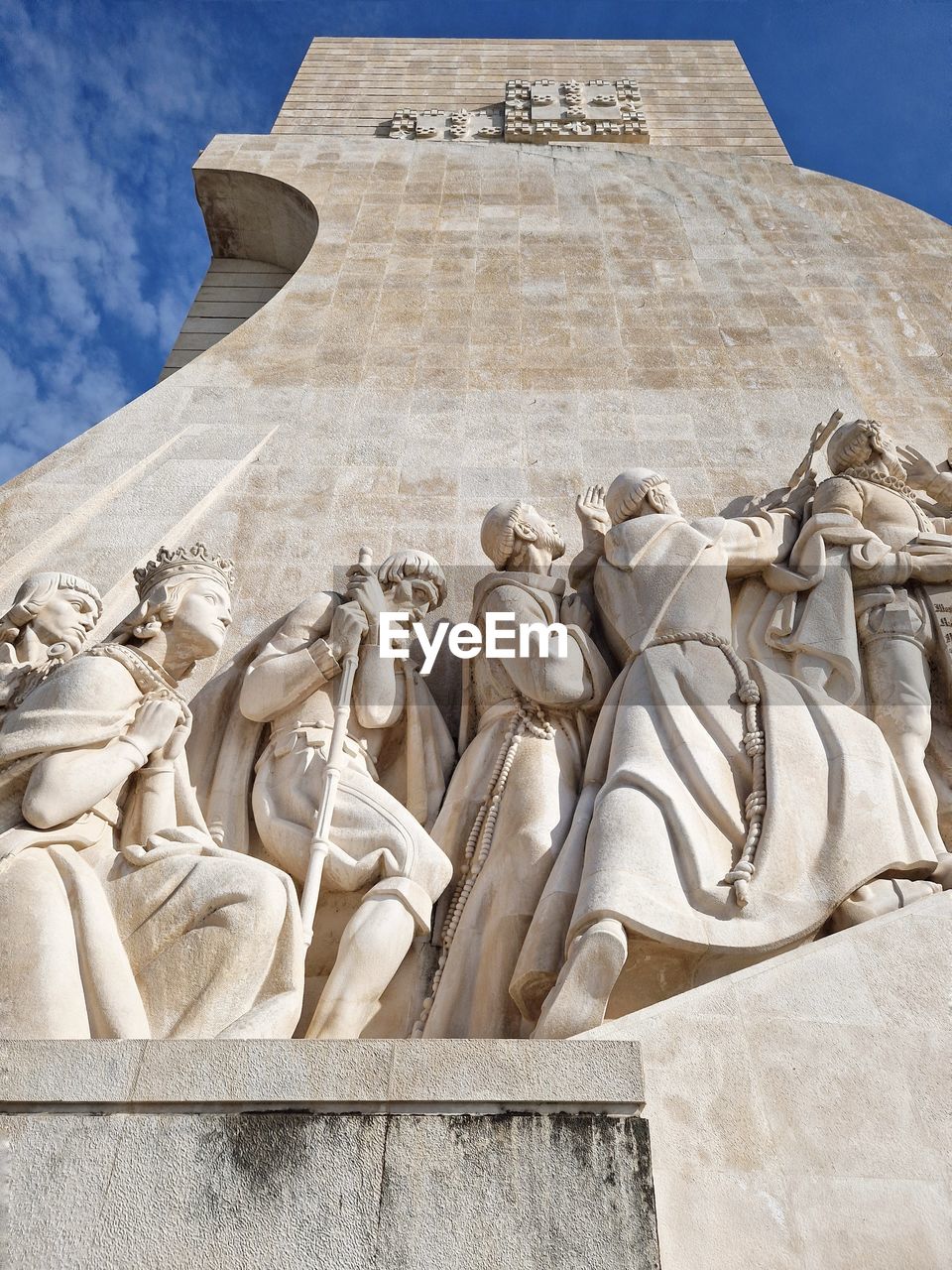 Looking up at landmark monument, with sculptures bathed in light