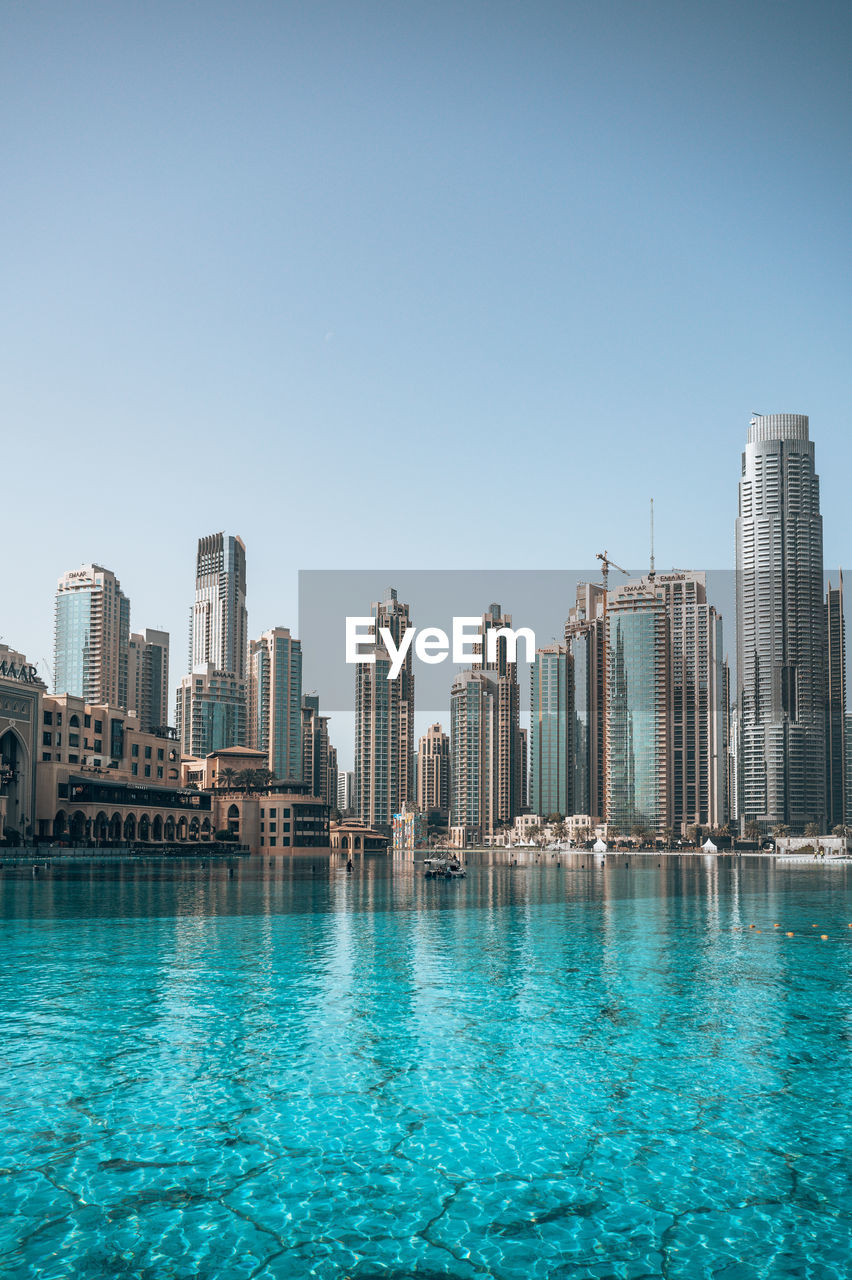 Modern buildings in city against clear sky