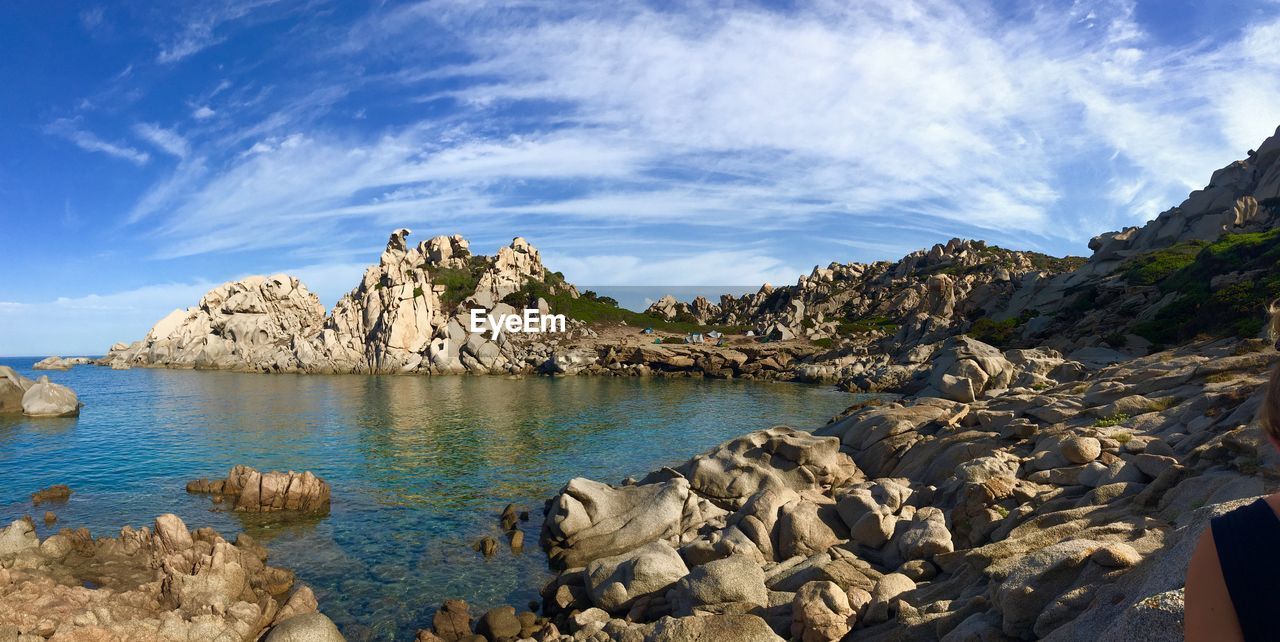 Panoramic view of rocks and sea against sky