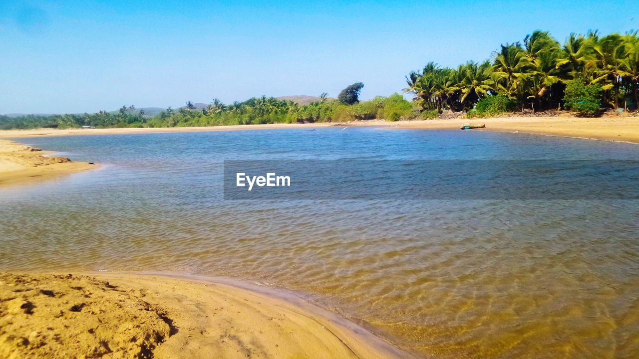 Scenic view of beach against clear sky