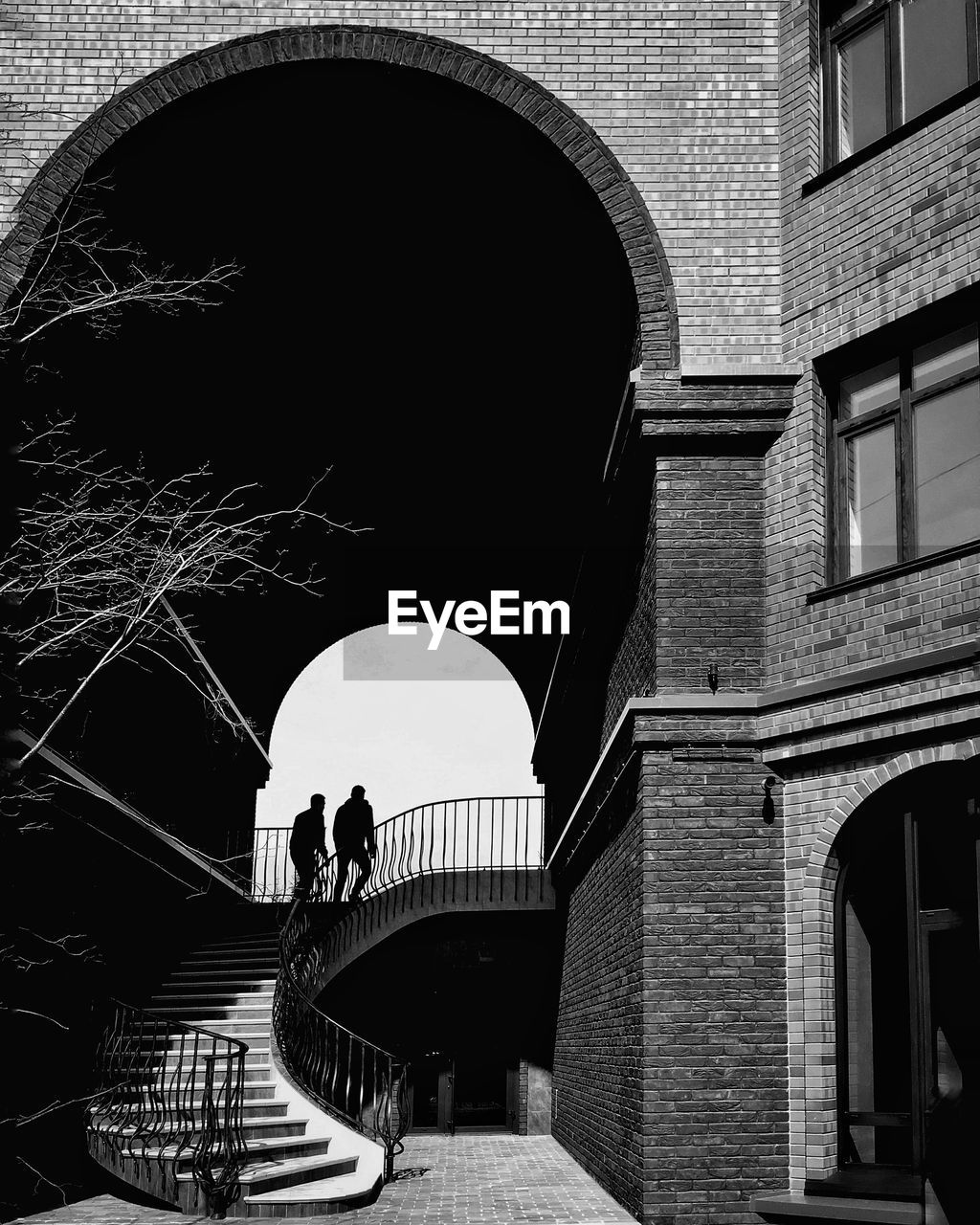 Silhouette men on staircase of building