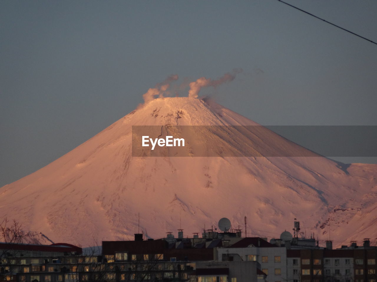 Aerial view of snowcapped mountain against sky