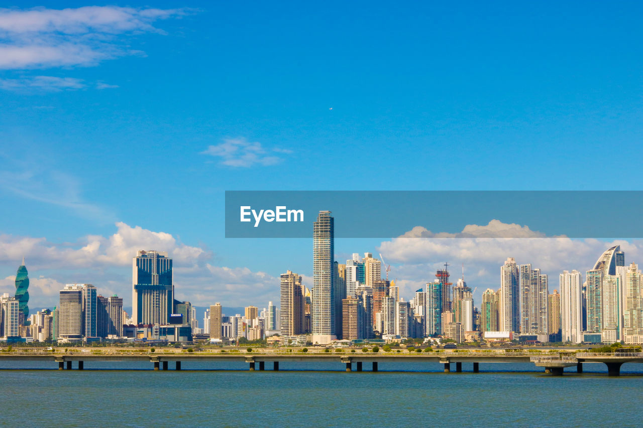 View of city skyline against blue sky