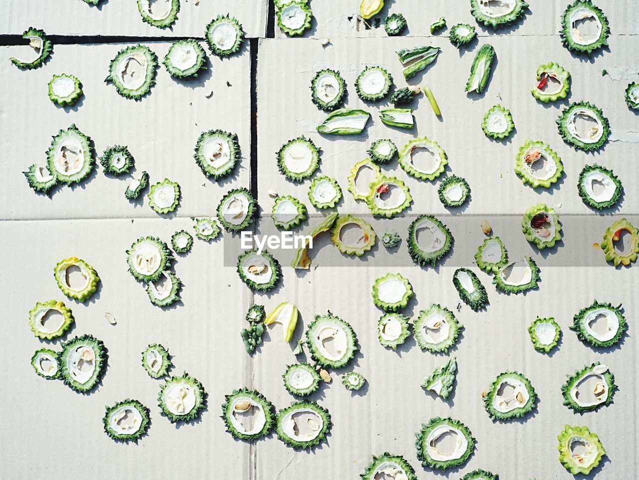 High angle view of sliced bitter melons on paper