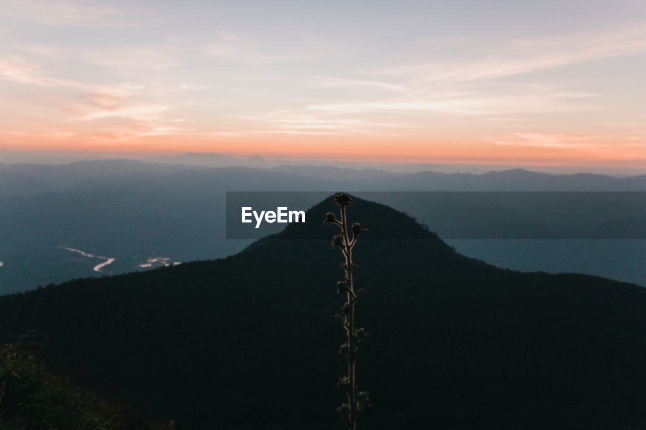 Scenic view of silhouette mountains against sky during sunset