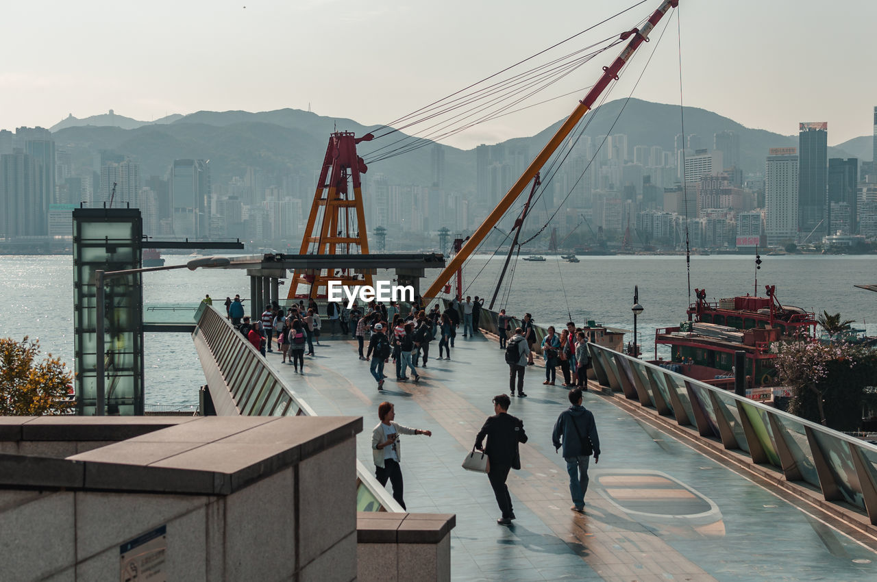 PEOPLE ON SUSPENSION BRIDGE OVER CITY