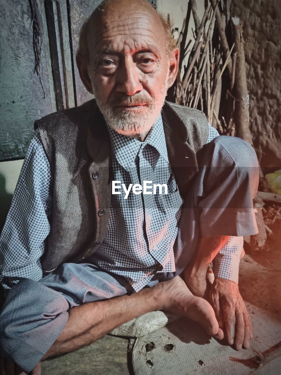 Portrait of man sitting on wall