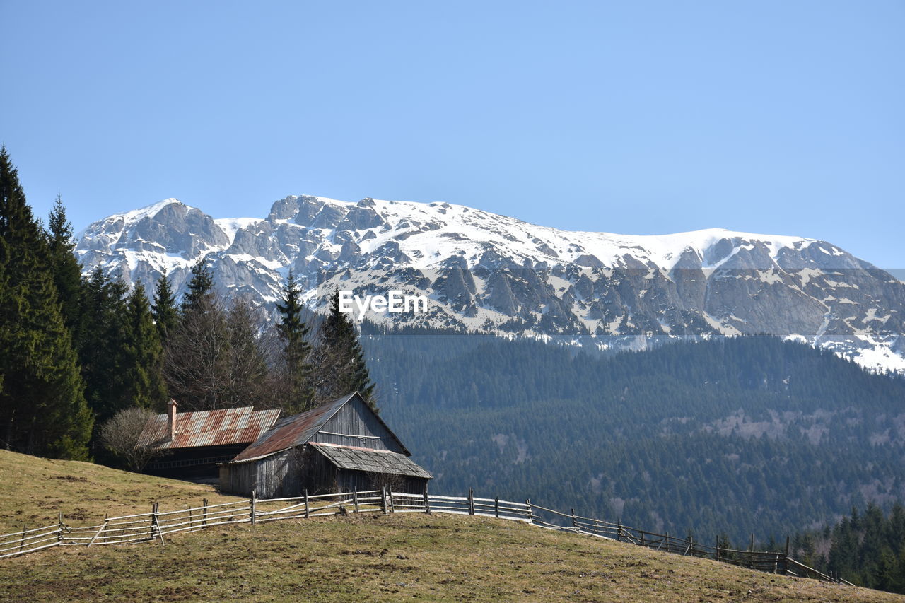 Scenic view of snowcapped mountains against clear sky