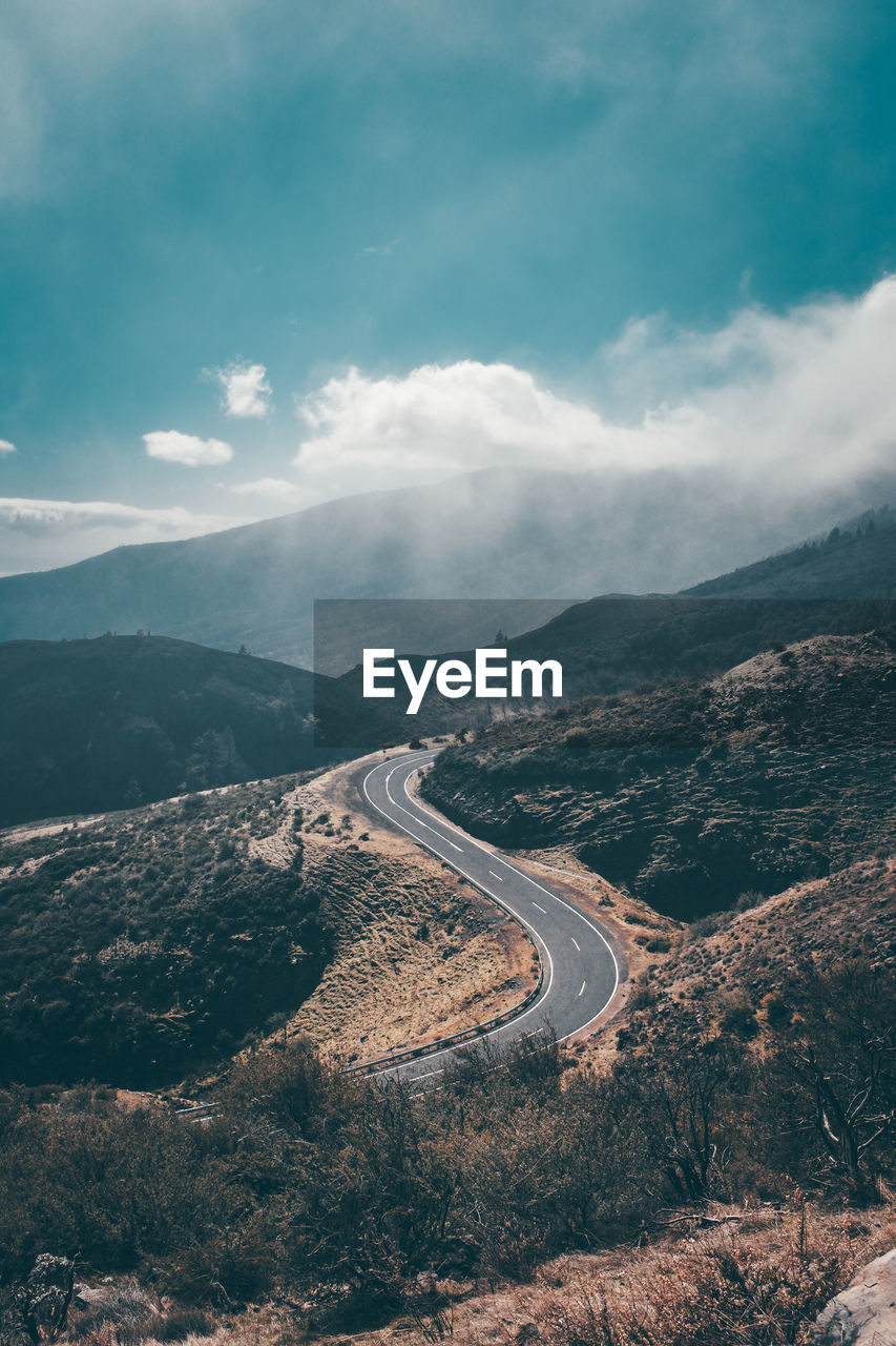 Aerial view of mountain road against cloudy sky