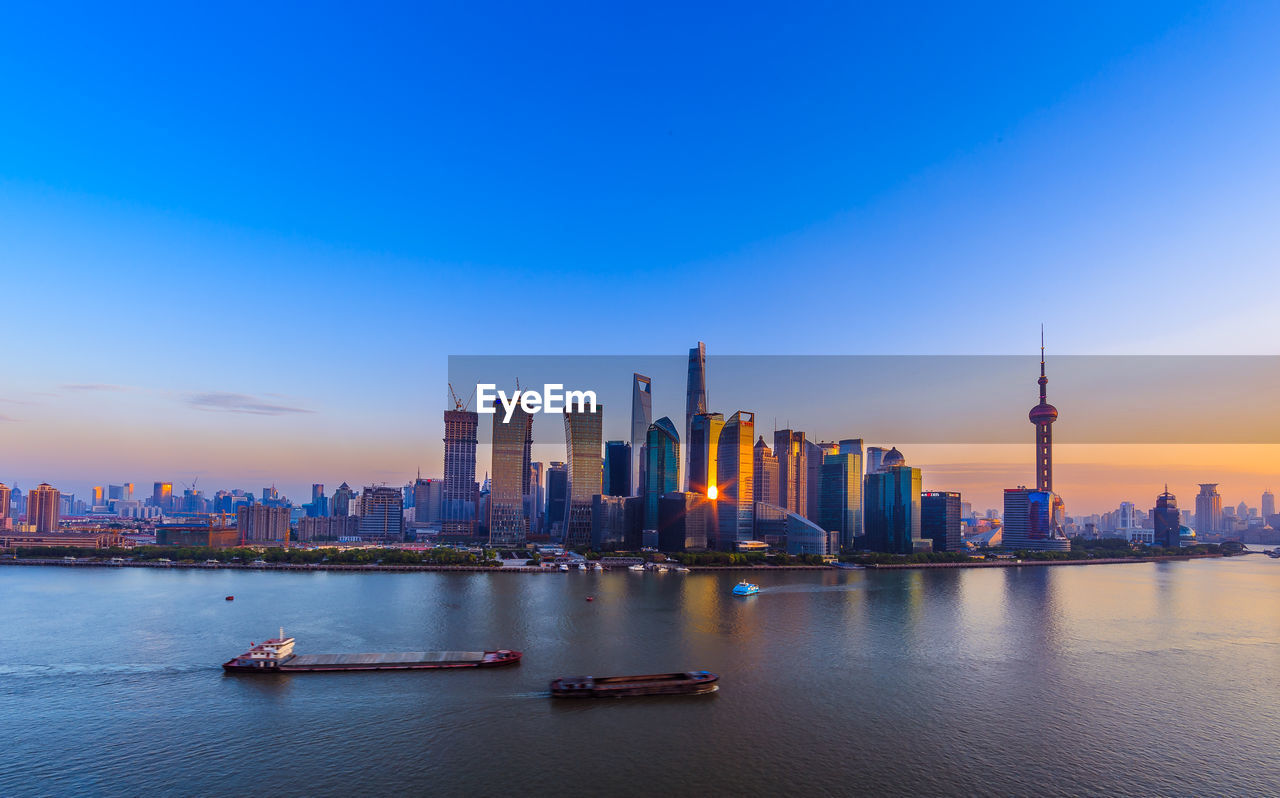 City skyline by the bank of huangpu river during sunset