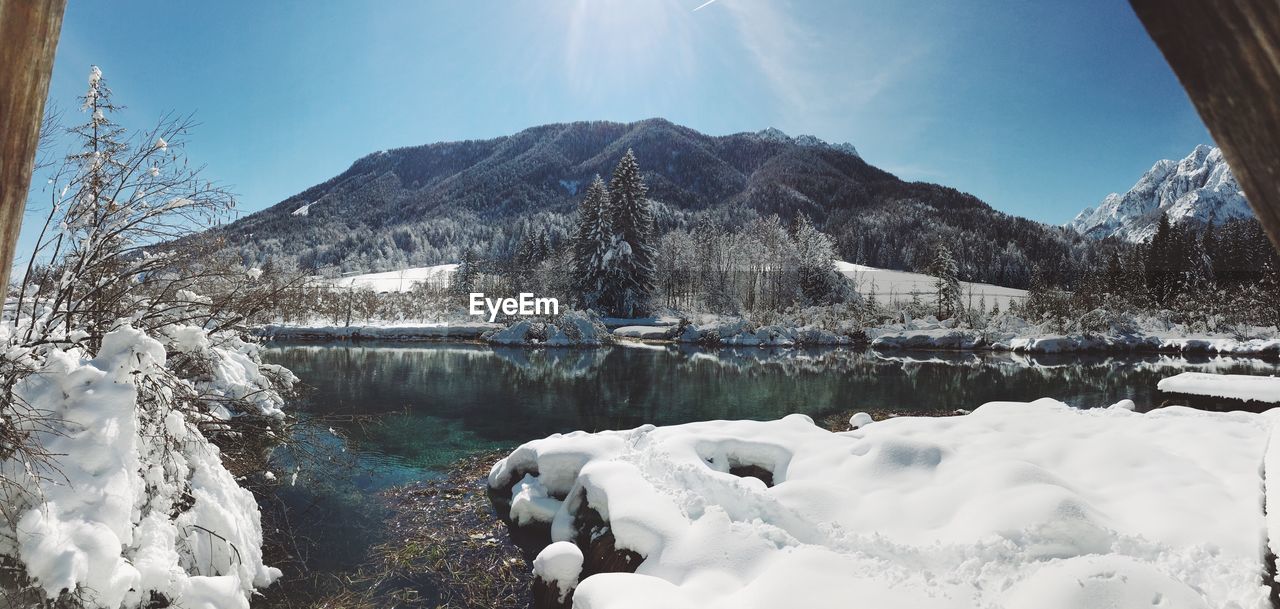 Calm lake along snowed landscape