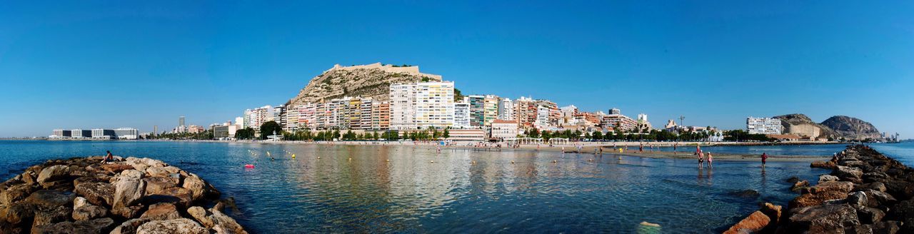 PANORAMIC VIEW OF SEA AND BUILDINGS AGAINST SKY