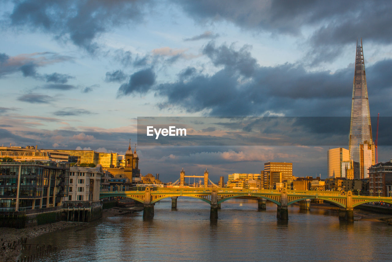 Bridge over river with buildings in background