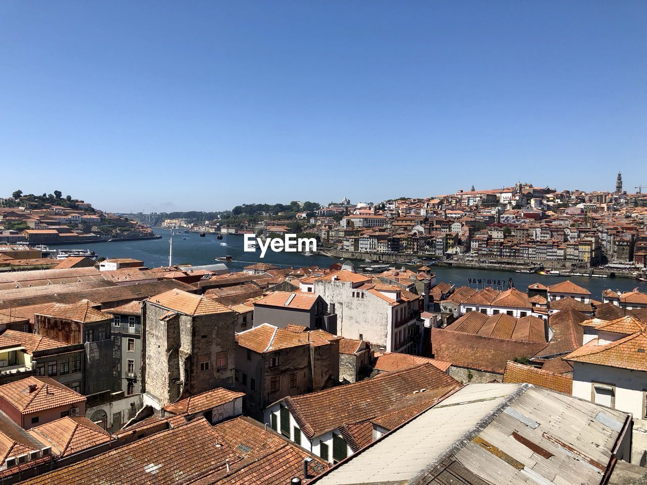 HIGH ANGLE SHOT OF TOWNSCAPE AGAINST BLUE SKY