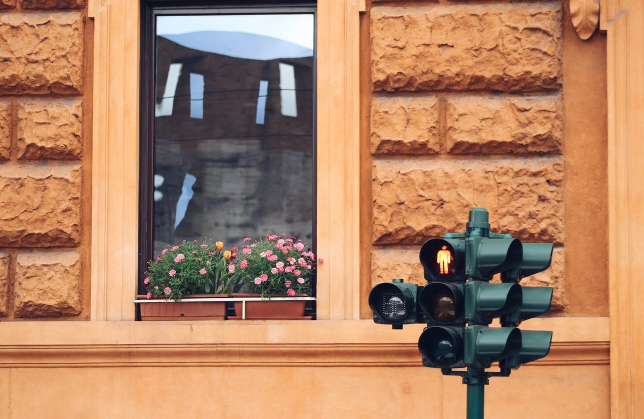 Low angle view of road signal against house