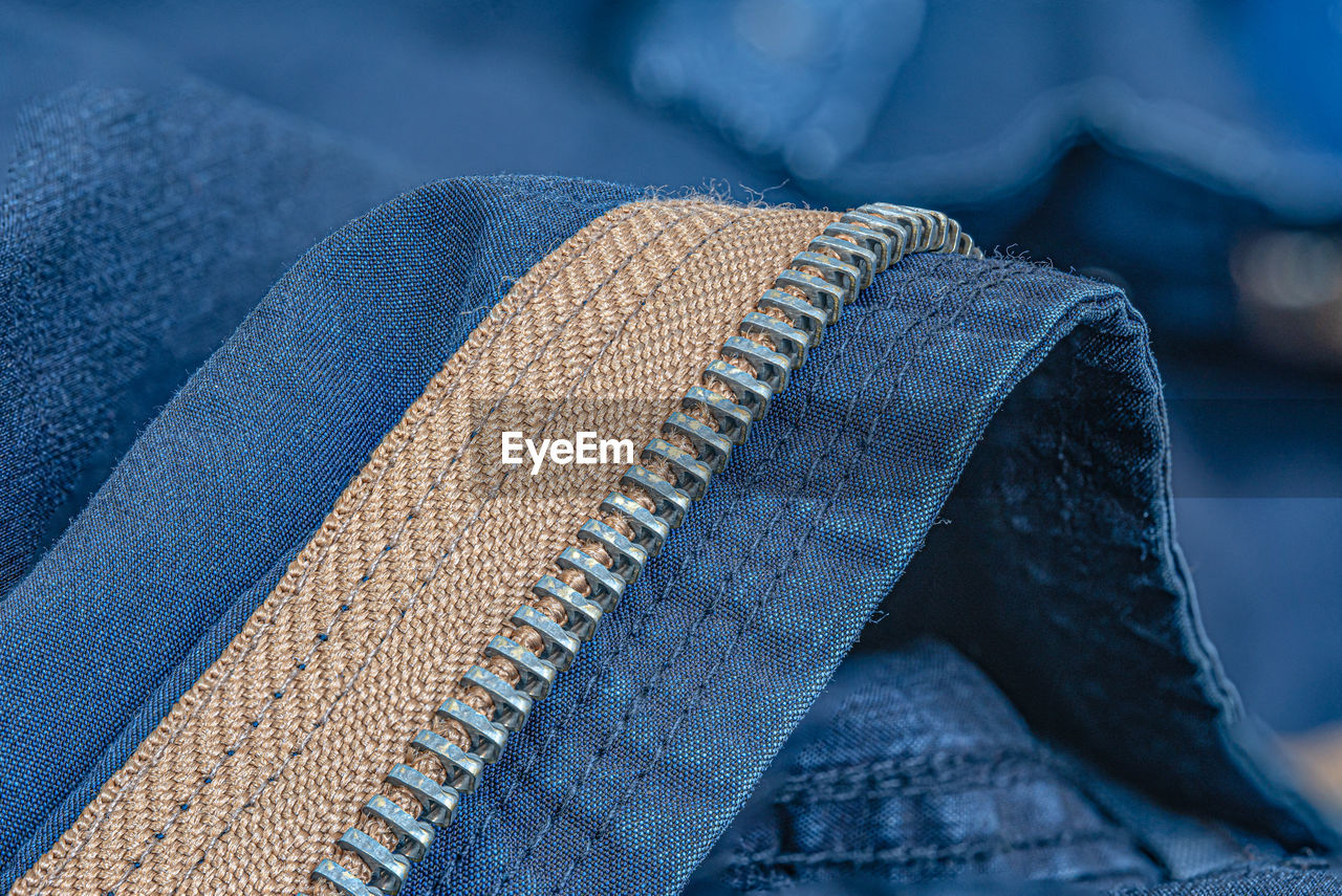 Close up shot of a blue textile jeans zipper