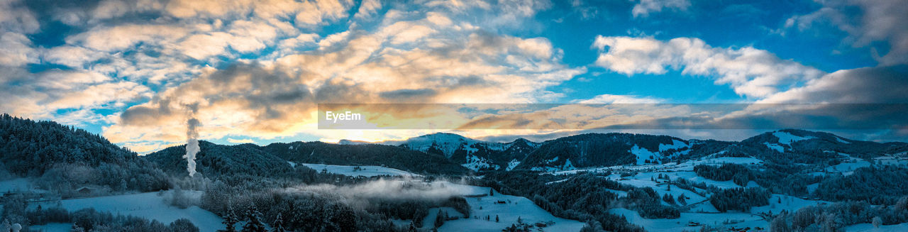 cloud, scenics - nature, mountain, environment, sky, snow, winter, beauty in nature, cold temperature, landscape, panoramic, mountain range, nature, tranquility, tranquil scene, no people, land, tree, travel destinations, forest, non-urban scene, travel, plant, coniferous tree, snowcapped mountain, pinaceae, pine tree, outdoors, mountain peak, blue, sunset, dramatic sky, idyllic, tourism, sun, cloudscape, sunlight, extreme terrain, ice