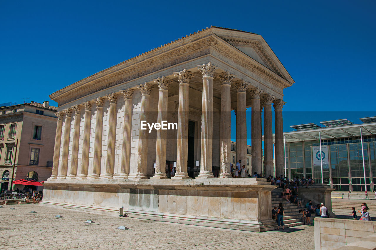 View of the maison carree, an ancient roman temple in the city center of nimes, france.