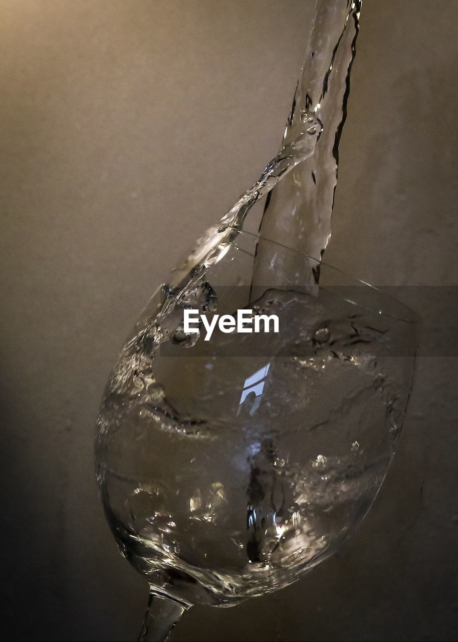 Close-up of pouring water in glass