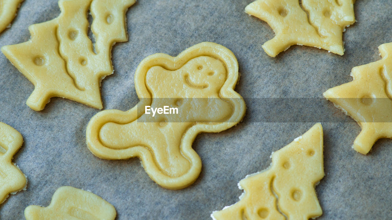 Raw christmas home made biscuits cookies. gingerbread man shaped cookie. 