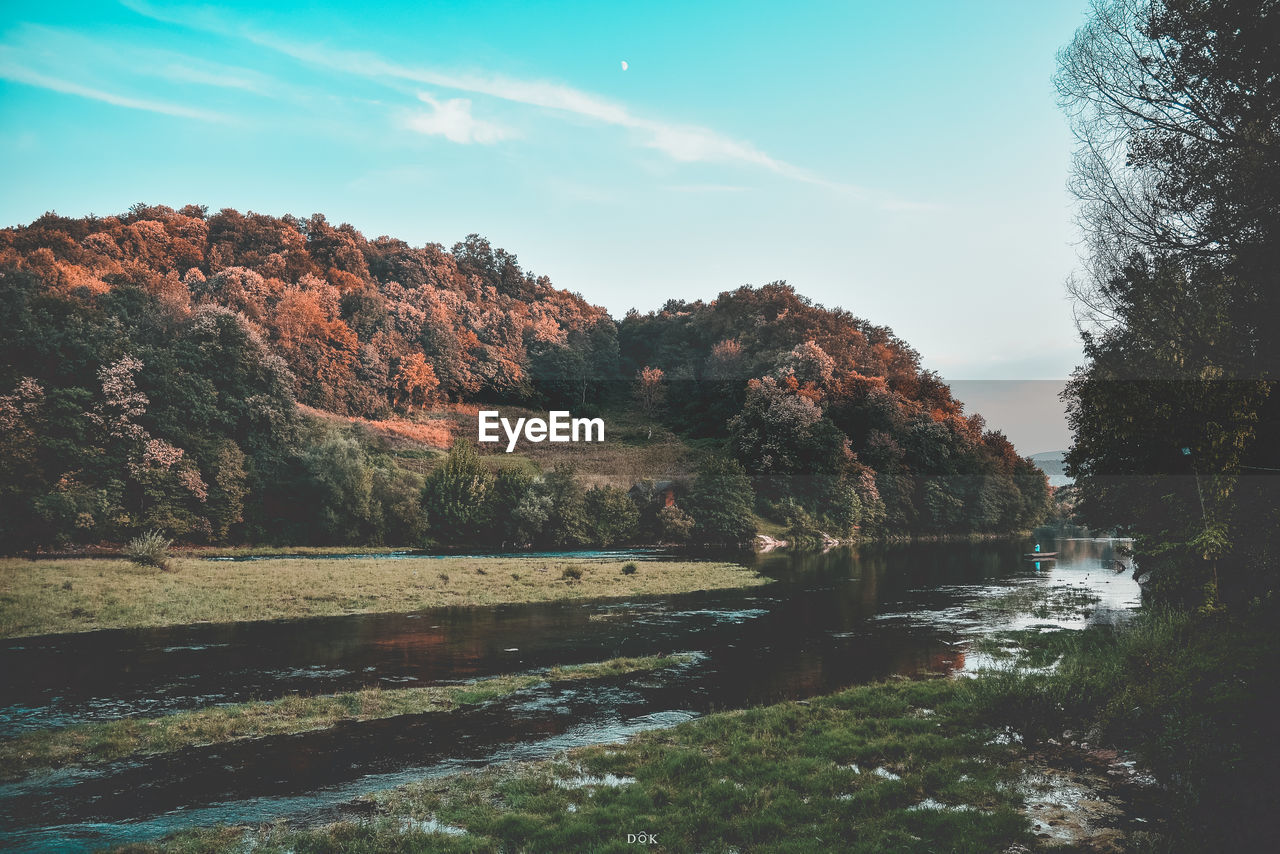 Scenic view of river against sky during autumn