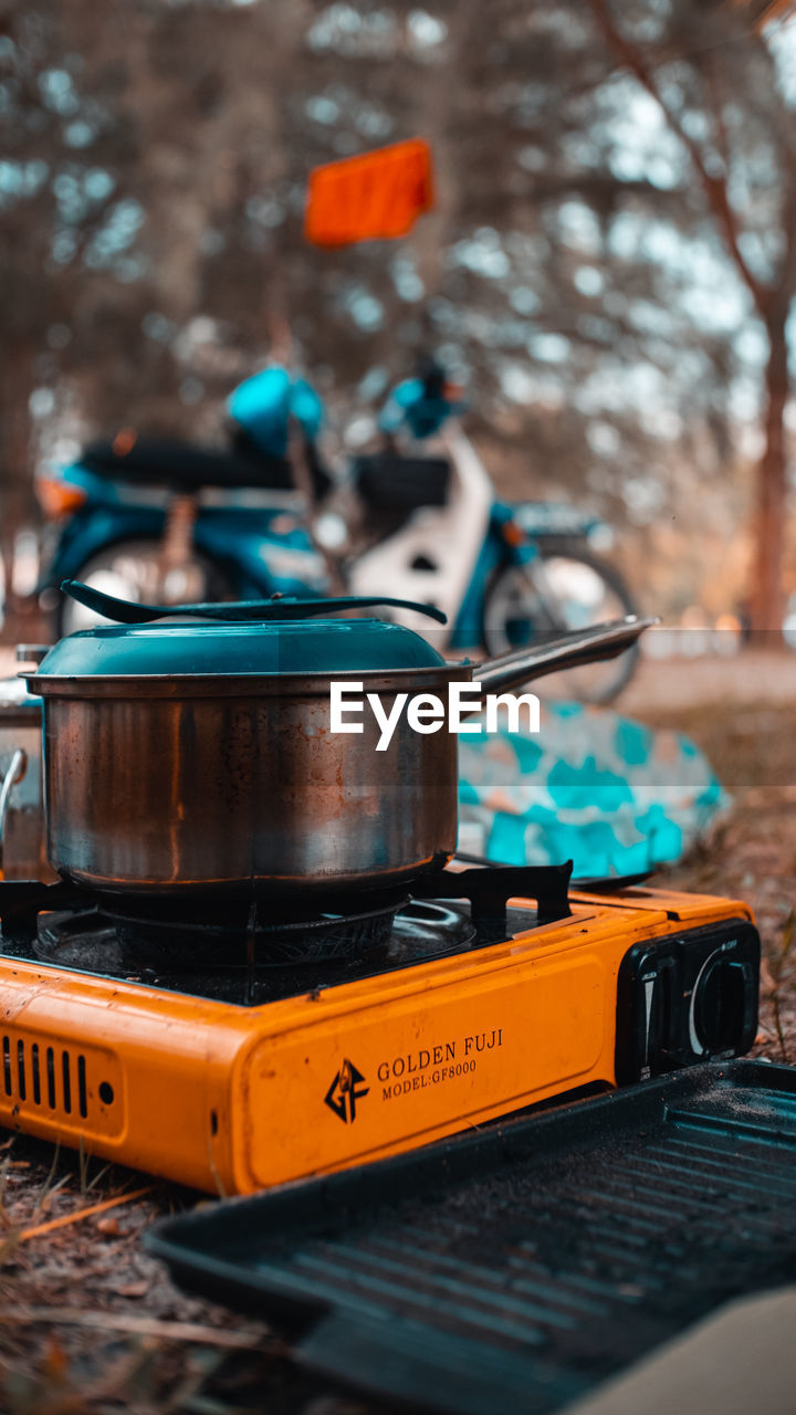 vehicle, no people, tree, blue, focus on foreground, music, nature, musical instrument, yellow, arts culture and entertainment, car, outdoors, transportation, mode of transportation, day