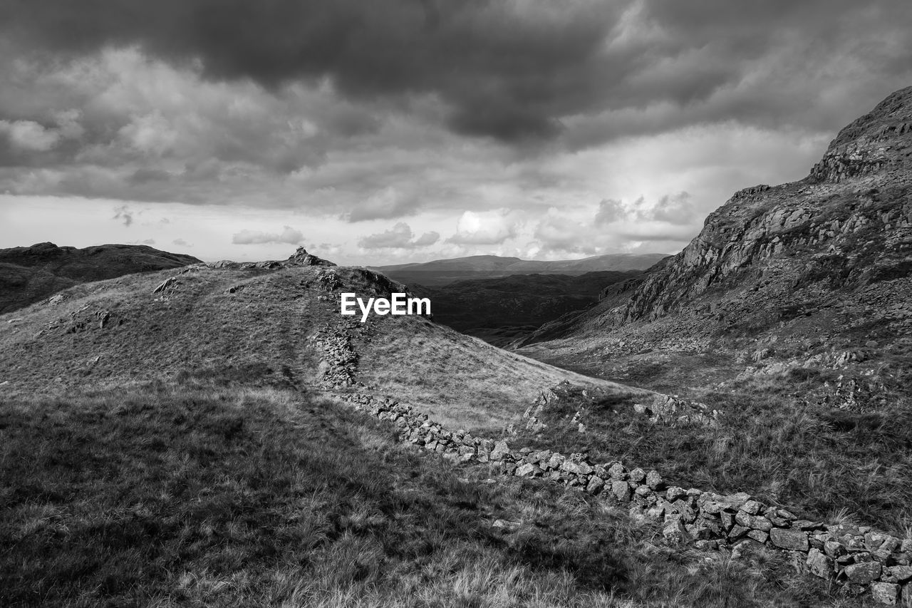 Scenic view of mountains against cloudy sky