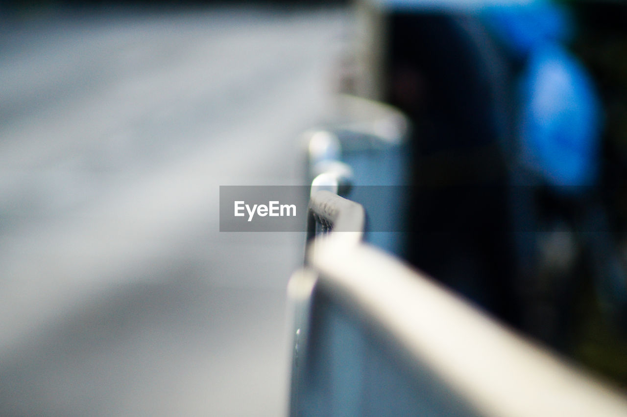 Defocused image of railing on road