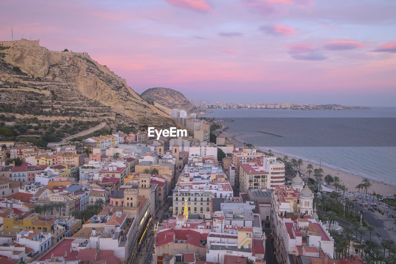 Aerial view of alicante city and beach at sunset, spain.