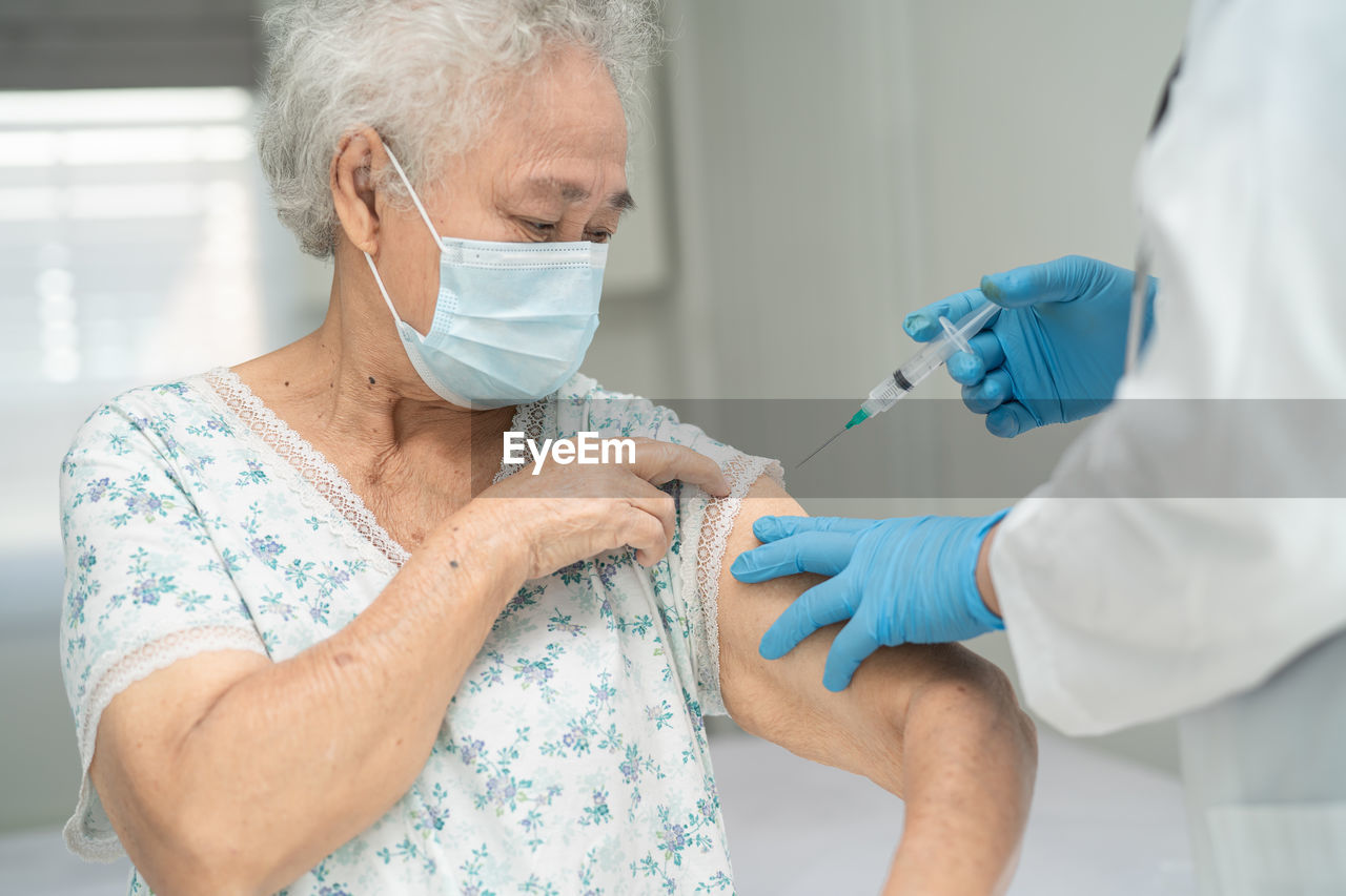 midsection of dentist examining patient