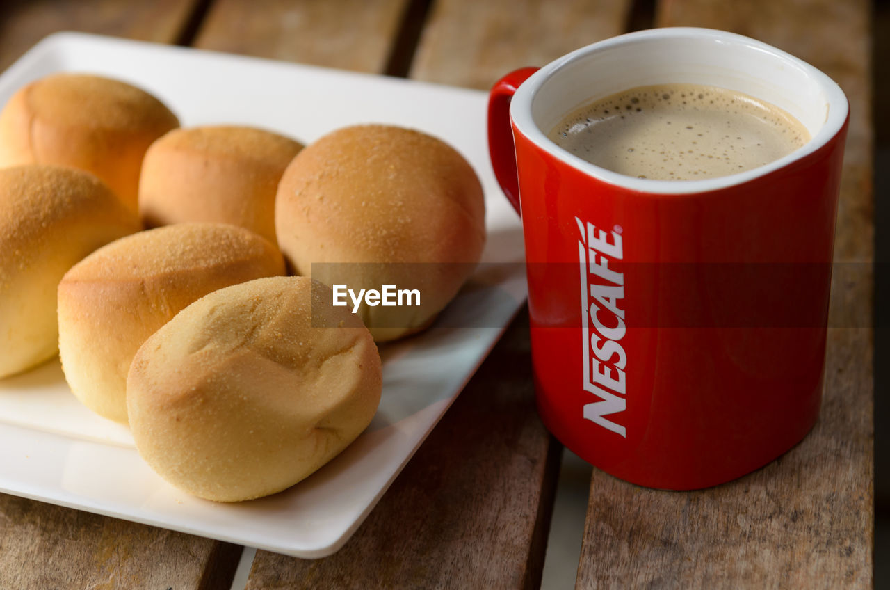 HIGH ANGLE VIEW OF COFFEE CUP WITH CREAM