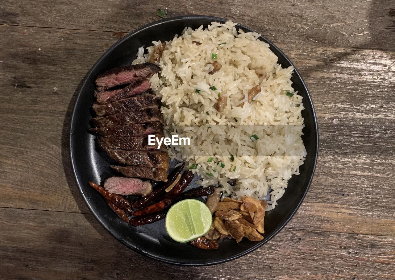 food and drink, food, rice, healthy eating, freshness, wellbeing, dish, table, bowl, rice - food staple, no people, vegetable, high angle view, produce, indoors, wood, jasmine rice, plate, still life, cuisine, basmati, meal, directly above, steamed rice, meat, asian food, serving size, white rice
