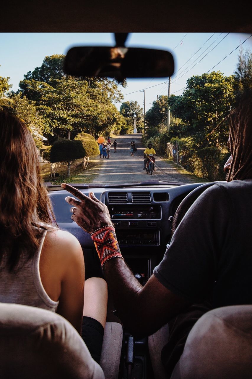 Close-up of man and woman in car